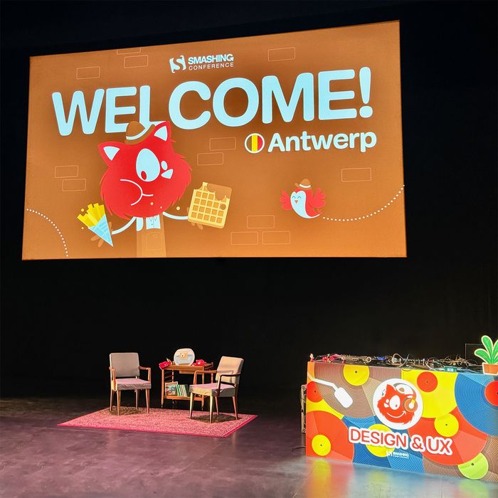 SmashingConf stage with DJ-table and chairs for discussions